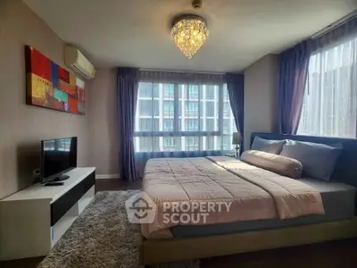 Luxurious bedroom with modern decor and large windows in high-rise apartment