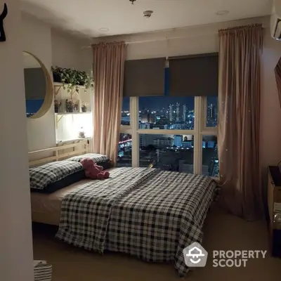 Cozy bedroom with city view, plaid bedding, and ambient lighting