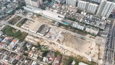 Aerial view of urban development site with surrounding residential buildings.