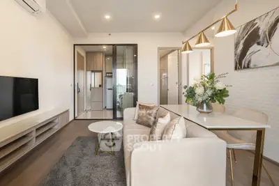 Modern living room with elegant decor and open layout, featuring a cozy sofa and stylish dining area.
