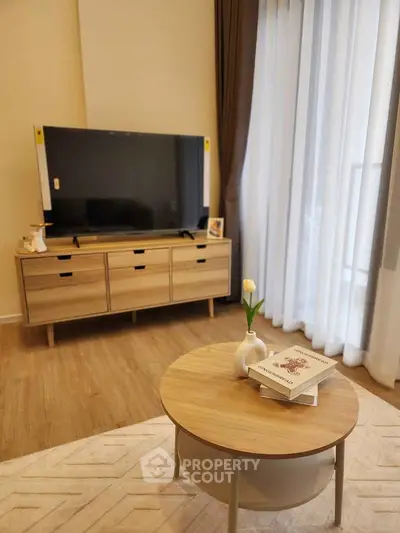 Modern living room with stylish wooden furniture and large TV, perfect for relaxation.