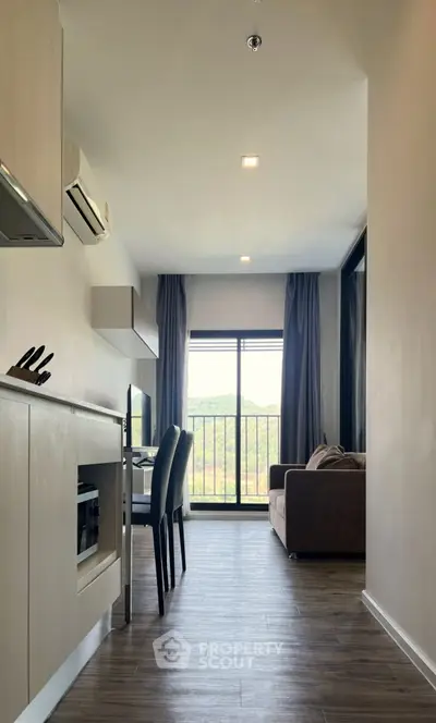 Modern apartment interior with open layout and scenic view from balcony.