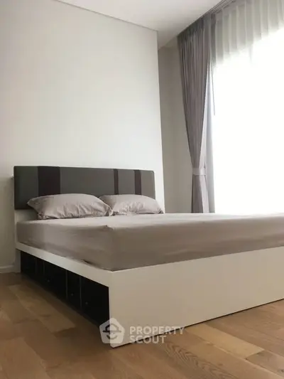 Modern bedroom with stylish bed and elegant curtains in a bright, minimalist design.