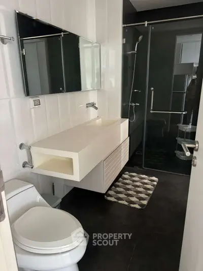 Modern bathroom with sleek fixtures and glass shower enclosure