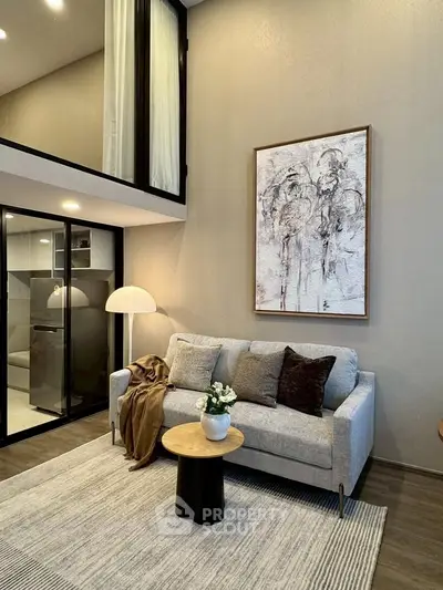 Modern living room with stylish decor and cozy ambiance, featuring a plush sofa and elegant artwork.