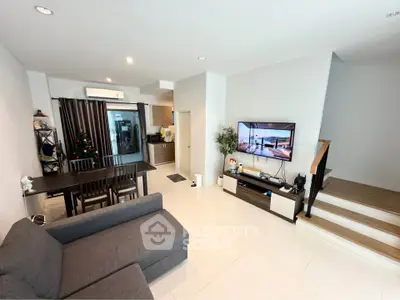 Modern living room with sleek furniture and open kitchen layout