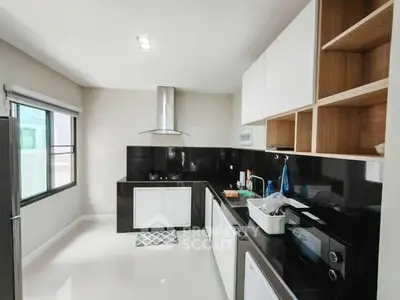 Modern kitchen with sleek black countertops and open shelving
