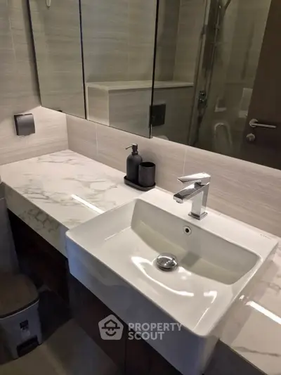 Modern bathroom with sleek sink and marble countertop