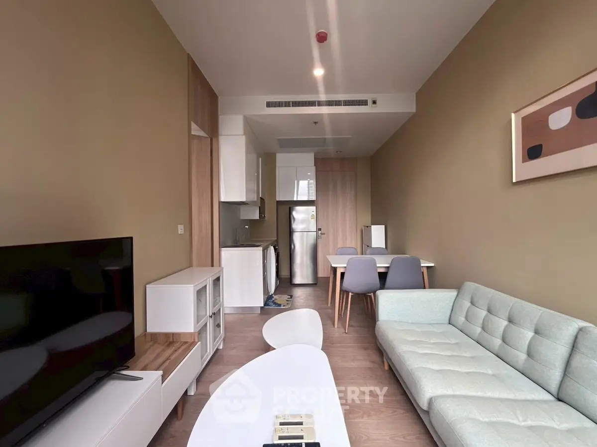 Modern living room with sleek furniture and open kitchen layout