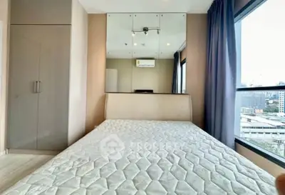 Modern bedroom with large window and mirrored wall in urban apartment