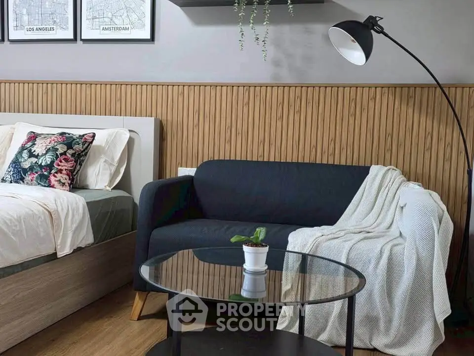 Stylish bedroom with cozy sofa and modern decor, perfect for relaxation and comfort.