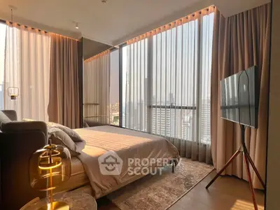 Luxurious bedroom with floor-to-ceiling windows and city view, featuring elegant decor and modern furnishings.