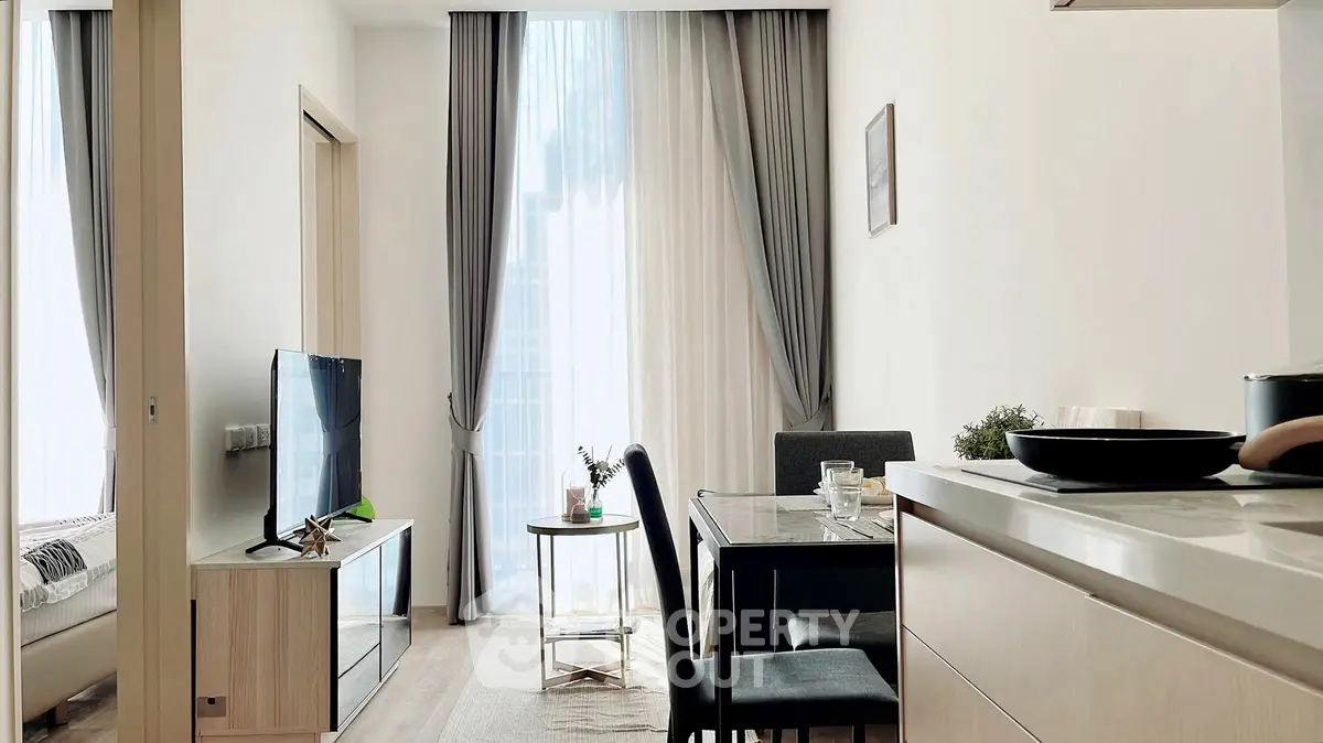 Modern living room with elegant dining area and large window drapes