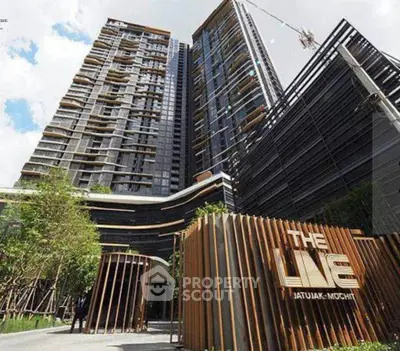 Modern high-rise condominium with sleek architecture and lush landscaping at The Line Jatujak-Mochit.