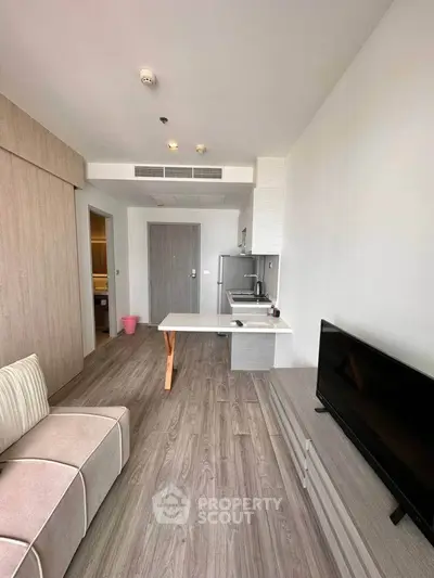 Modern living room with open kitchen and sleek design