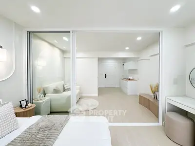 Modern open-plan living room with neutral tones and sleek furniture design