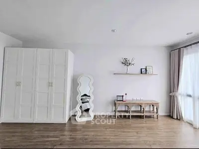 Spacious minimalist living room with wooden flooring and modern decor
