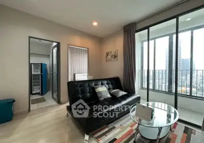 Modern living room with black leather sofa and city view balcony