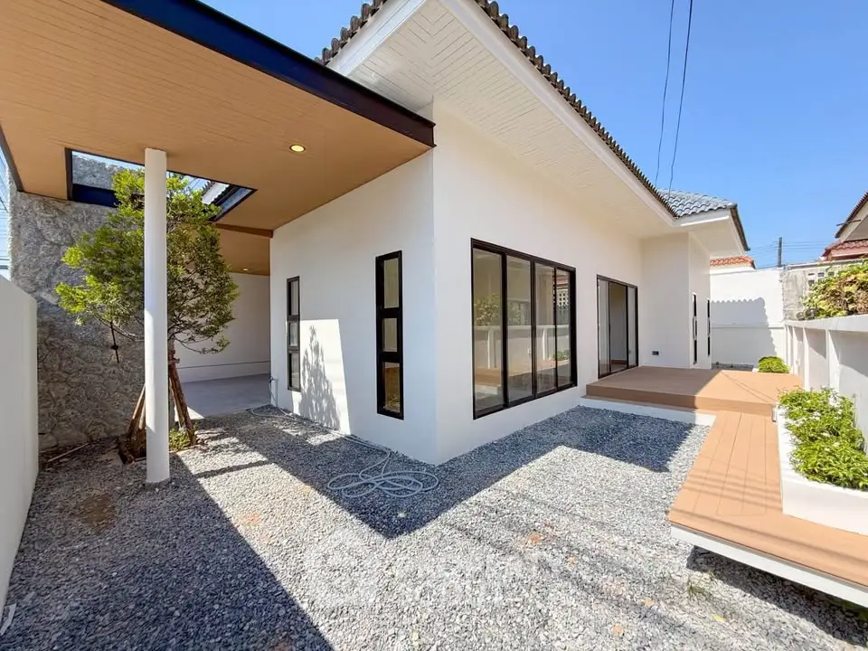 Modern single-story home with sleek design, large windows, and a spacious outdoor area perfect for relaxation.