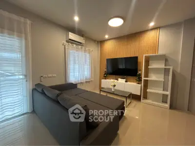 Modern living room with sleek furniture and wall-mounted TV