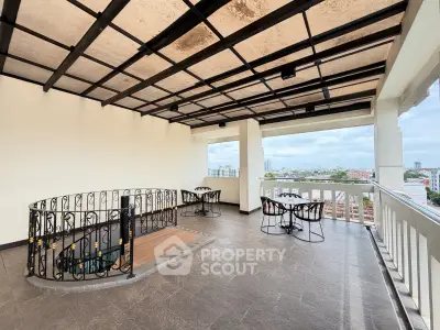 Spacious rooftop terrace with panoramic city views and stylish seating area.
