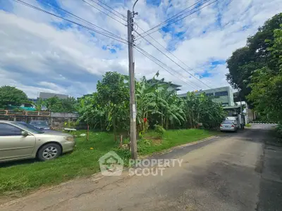 Spacious residential plot with lush greenery and street access, ideal for development.