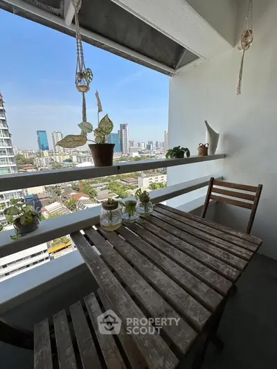Charming balcony with wooden table and city skyline view, perfect for relaxing and enjoying the outdoors.