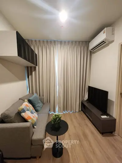 Modern living room with cozy sofa, TV, and air conditioning in stylish apartment.