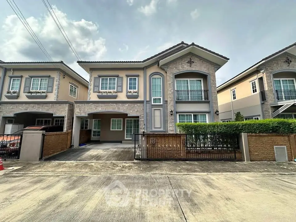 Charming two-story townhouse with modern facade and spacious driveway in a serene neighborhood.