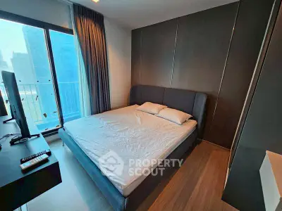 Modern bedroom with sleek design and large window offering city views