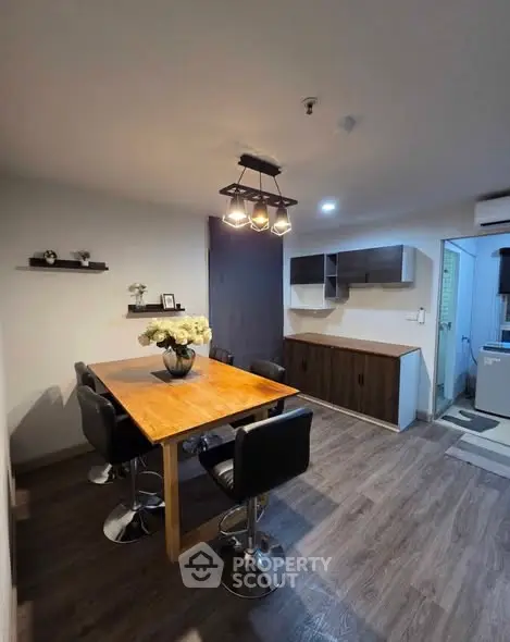 Modern dining area with stylish lighting and wooden flooring