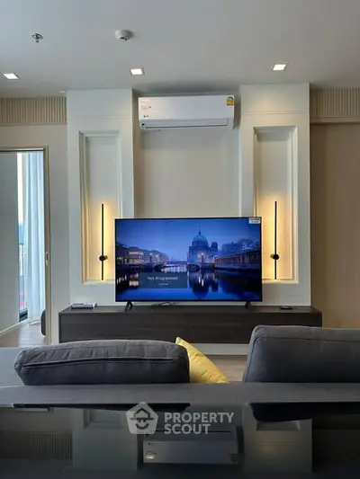 Modern living room with sleek TV setup and stylish lighting