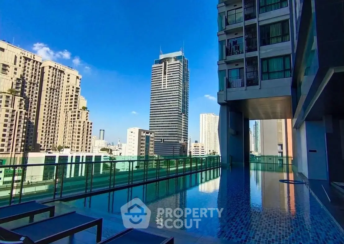Luxurious rooftop pool with stunning city skyline views in modern high-rise building.
