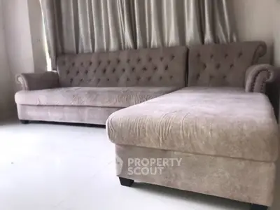 Elegant living room with plush beige sofa and stylish curtains