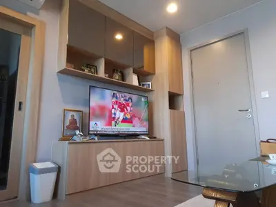 Modern living room with wooden cabinetry and flat-screen TV, showcasing sleek design and cozy ambiance.