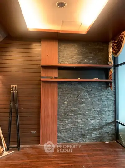 Luxurious interior with wooden paneling and stone accent wall, perfect for modern living spaces.