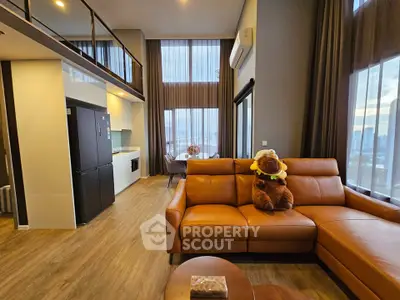 Luxurious high-ceiling living room with modern decor and stunning city view