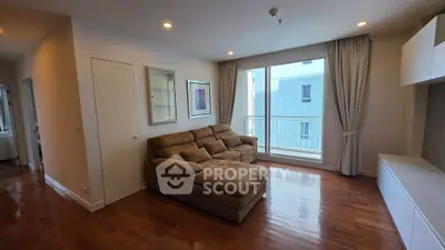 Spacious living room with plush sofa and large window in modern apartment