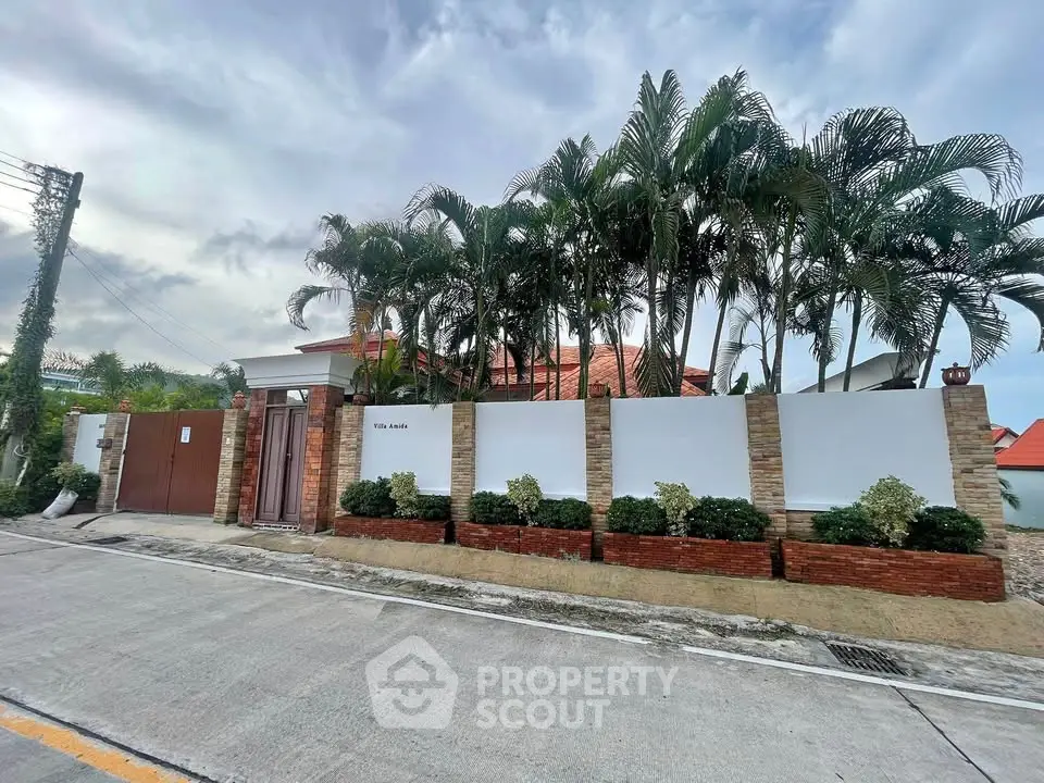 Stunning villa exterior with lush palm trees and modern design in a serene neighborhood.