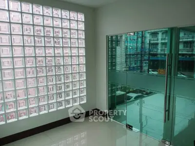 Modern interior with glass block wall and glass door entrance