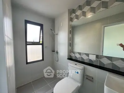 Modern bathroom with geometric tile design and sleek fixtures