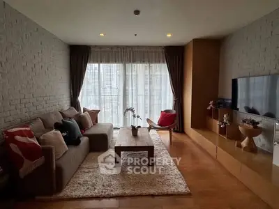 Stylish living room with modern decor and large windows offering city views.