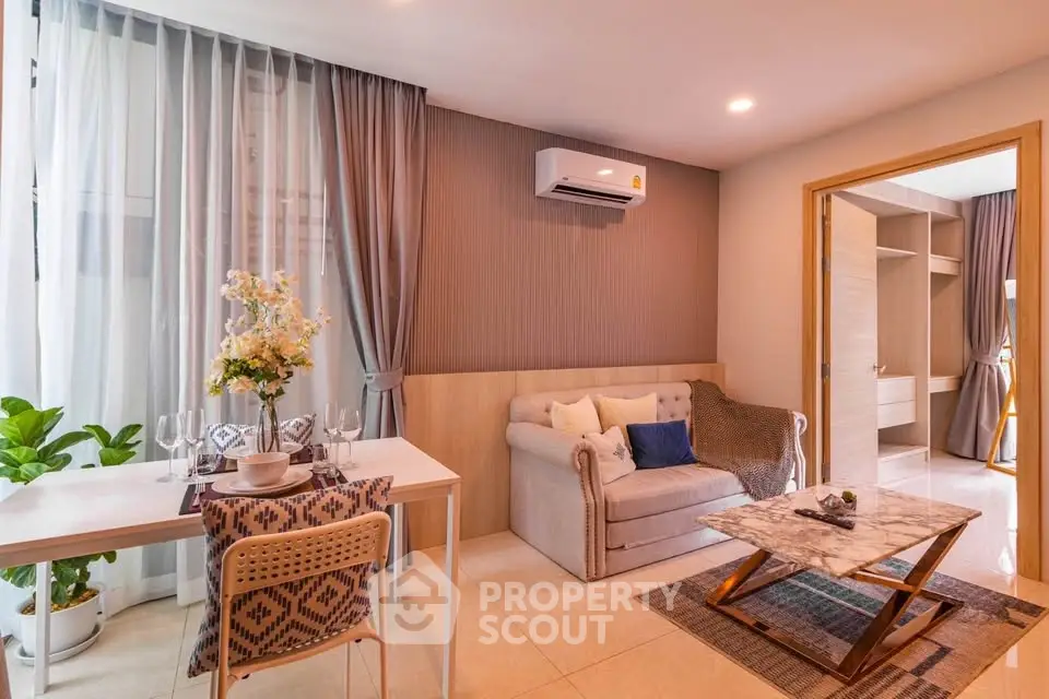 Charming living room with modern decor, cozy sofa, and elegant dining area, perfect for relaxation and entertaining.