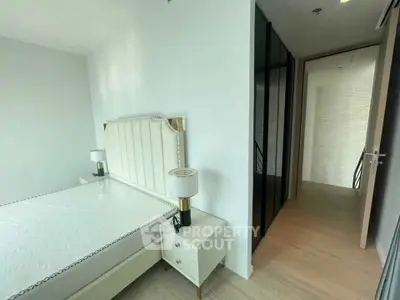 Modern bedroom with stylish headboard and bedside lamps in a contemporary apartment.