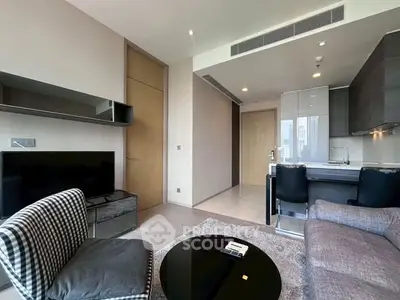 Modern living room with open kitchen and stylish furniture in a high-rise apartment.
