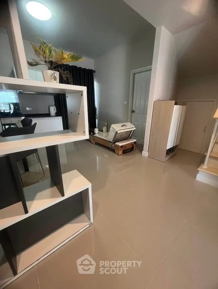 Modern interior with sleek shelving and cozy seating area, perfect for stylish living.