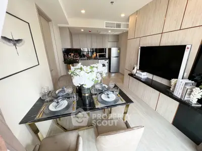 Elegant open-plan living space with a modern kitchen, dining area, and cozy lounge setup, perfect for entertaining and comfortable living.