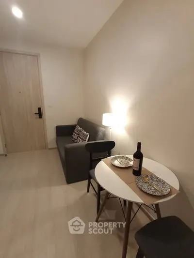 Cozy living room with modern decor and dining area, perfect for urban living.