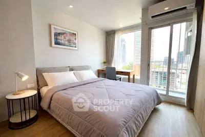 Modern bedroom with city view, featuring cozy bed, stylish decor, and natural light from large windows.
