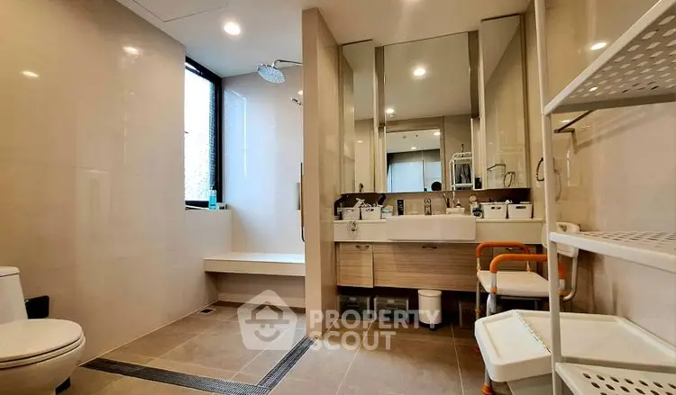 Spacious modern bathroom with sleek fixtures and large mirror